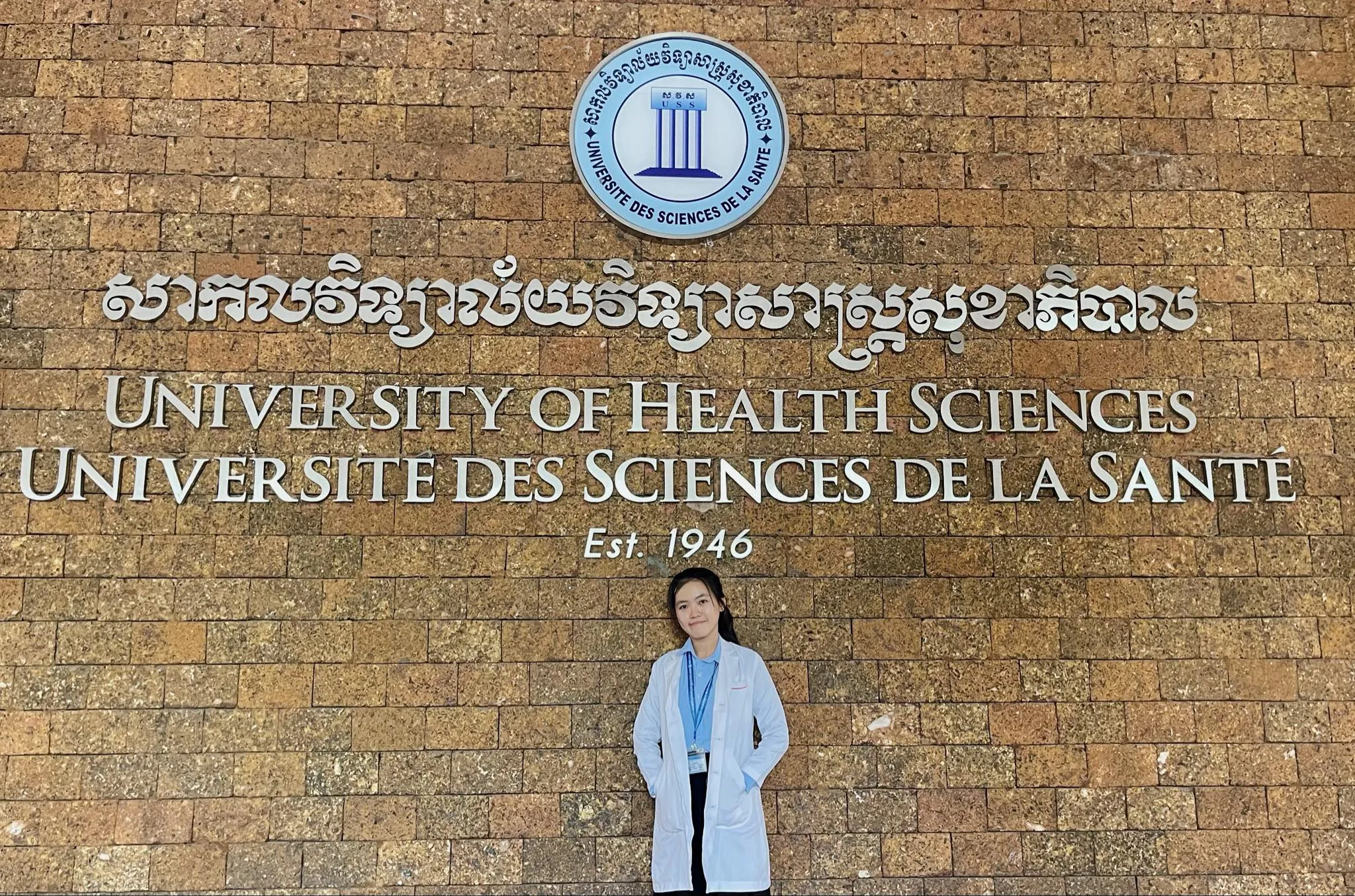 Srey Sor Chay in front of the university she just graduated from